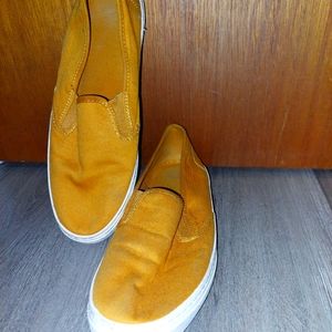 Gently worn slip-on sneaker.